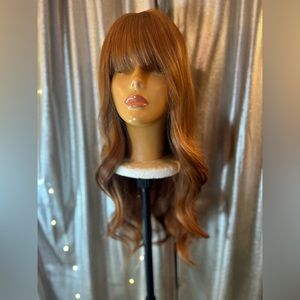 Auburn wavy thick wig with bangs.
